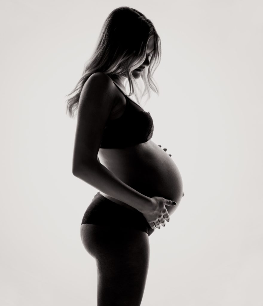 A woman holding her baby bump