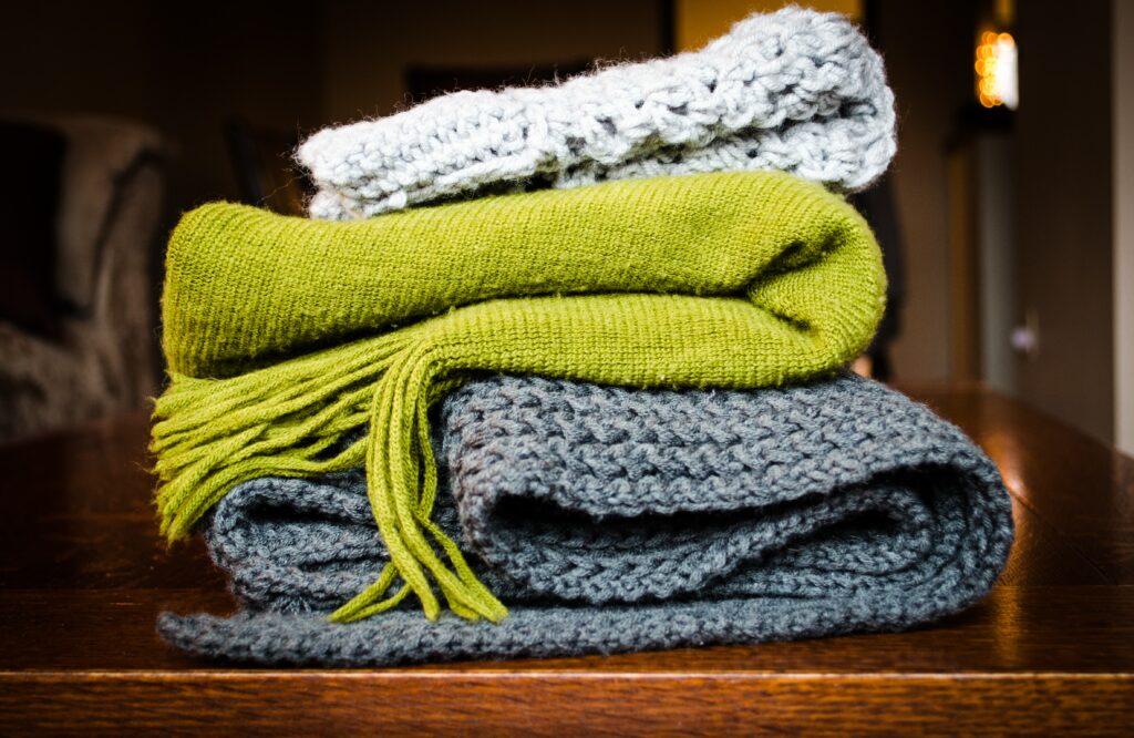 a pile of scarves to support your immune system in the winter